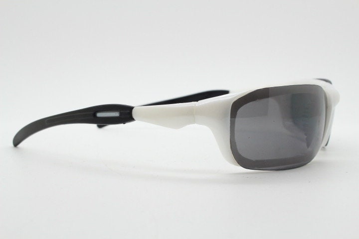 Y2K vintage visor sunglasses. Black and white superhero style sport shield with curved black lenses. Aerodynamic wrap around. NOS rave