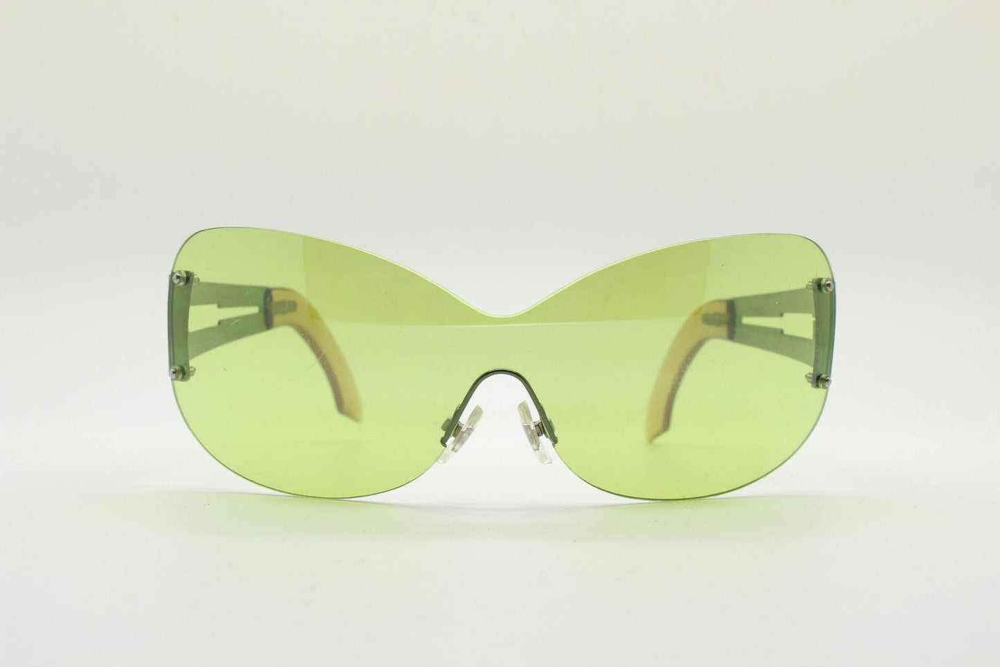 Y2K vintage frameless shield sunglasses. Dynamic 2000's green mono lens visor with matching coloured chrome arms. 00's Cosplay mini mask NOS