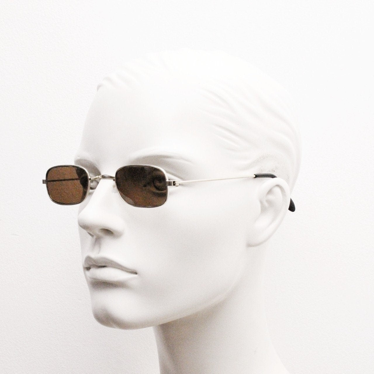 80s vintage rectangular low profile metal sunglasses. Minimal 60s mens mod design in gold chrome frame with brown lenses. NOS