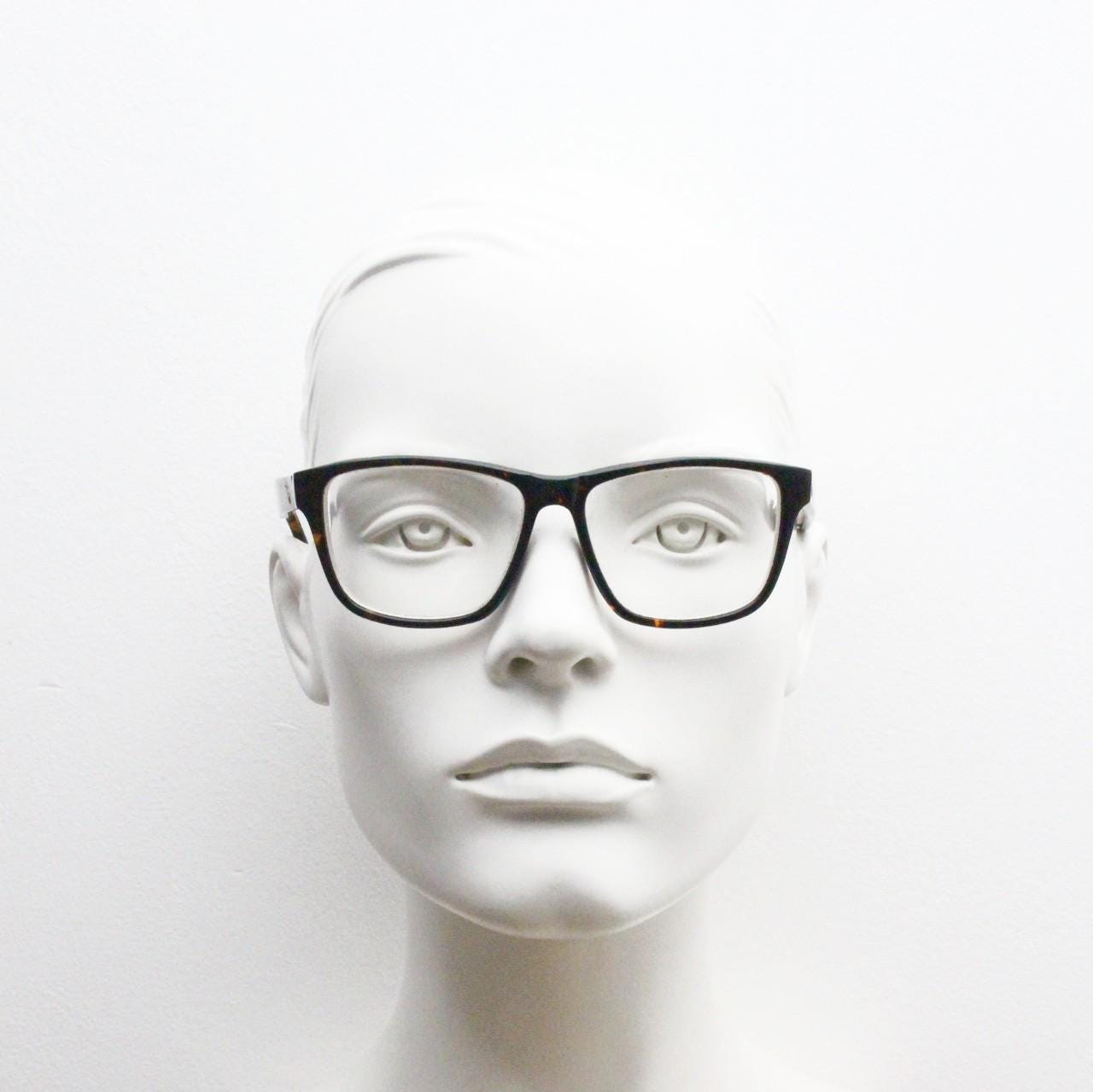 Cheap Monday rectangular low profile eye glasses. Dark brown tortoise gloss finish acetate optical frames. Prescription RX spectacles
