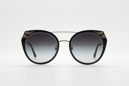 Bulgari round cropped cat eye sunglasses made in Italy. Womens black and gold frame with honeycomb patterns and smoky graduating lenses