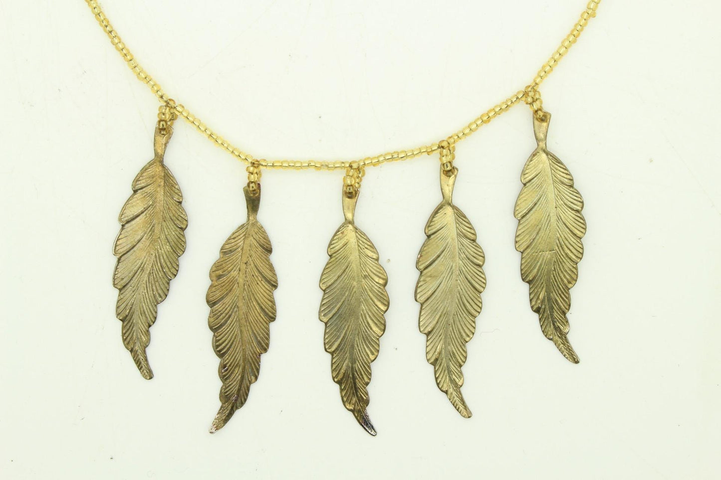 80s vintage gold beaded necklace with large dangling leaves . Charming statement piece. Country and western. Native american