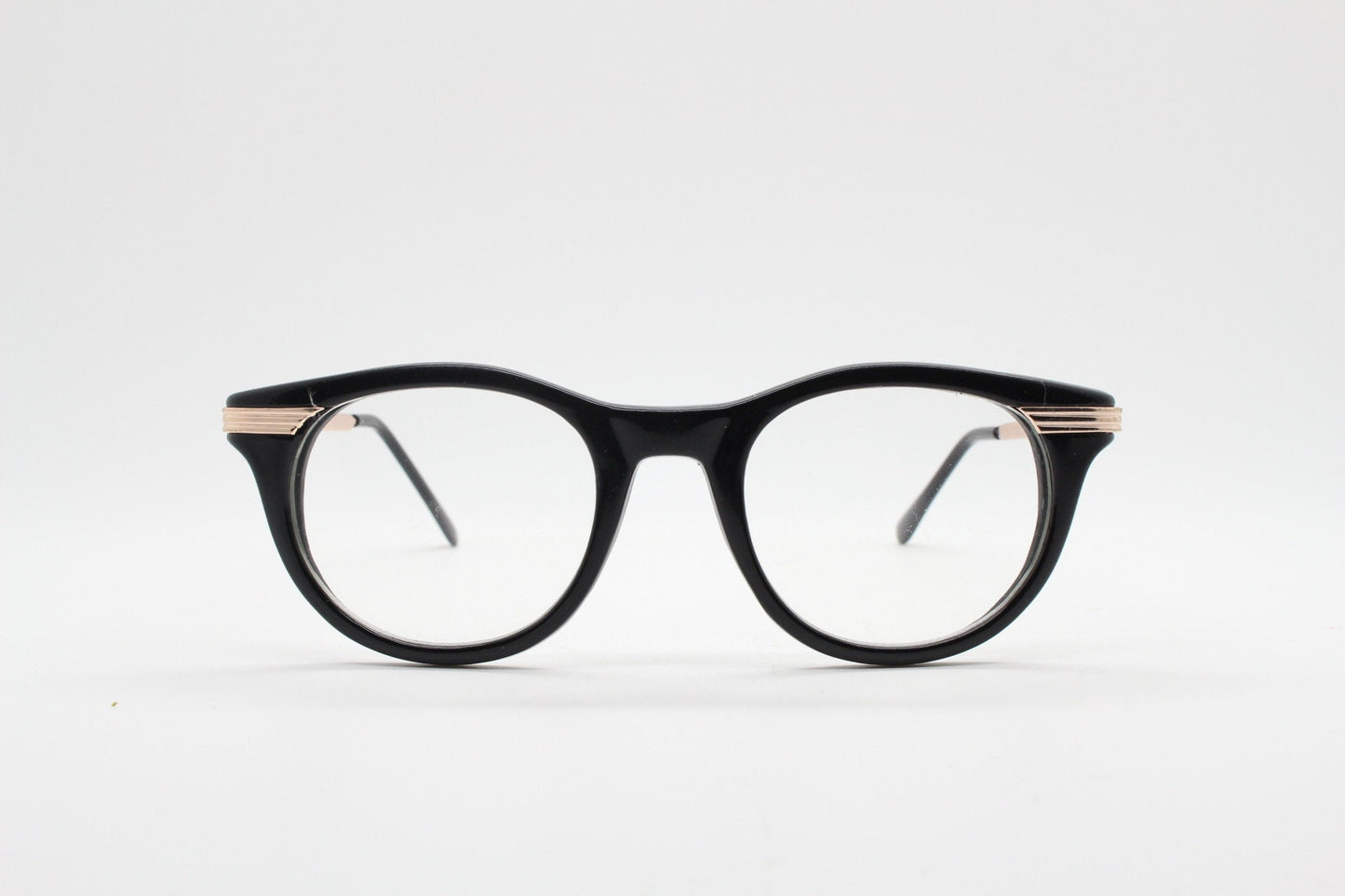 90s vintage cat eye glasses in black with gold metal arms. 50s, 60s style cateye prescription optical frames. Clear lens eyeglasses. RX