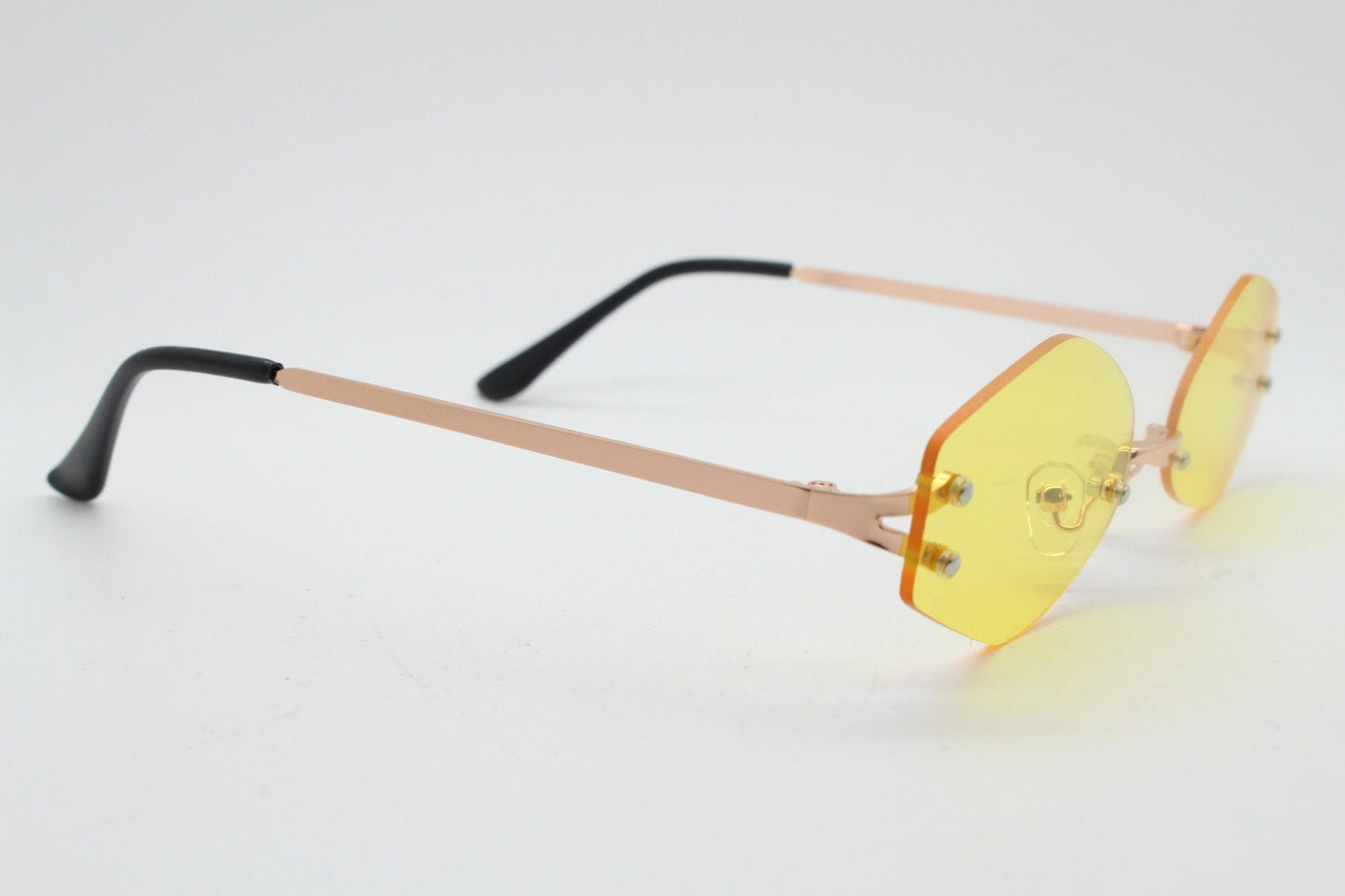 Y2K vintage frameless hexagon sunglasses. Bright yellow lenses with rose gold bridge and arms. 2000s, 00's. 90s