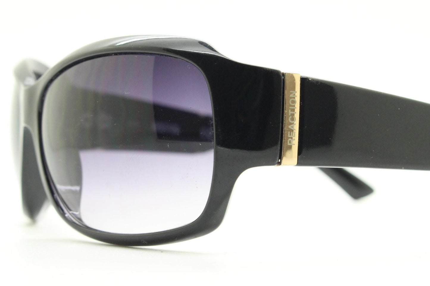 Y2k vintage wrap around sunglasses by Kenneth Cole Reaction. Curved black shield frame with gold trim. 60s bug eye design. 2000's NOS
