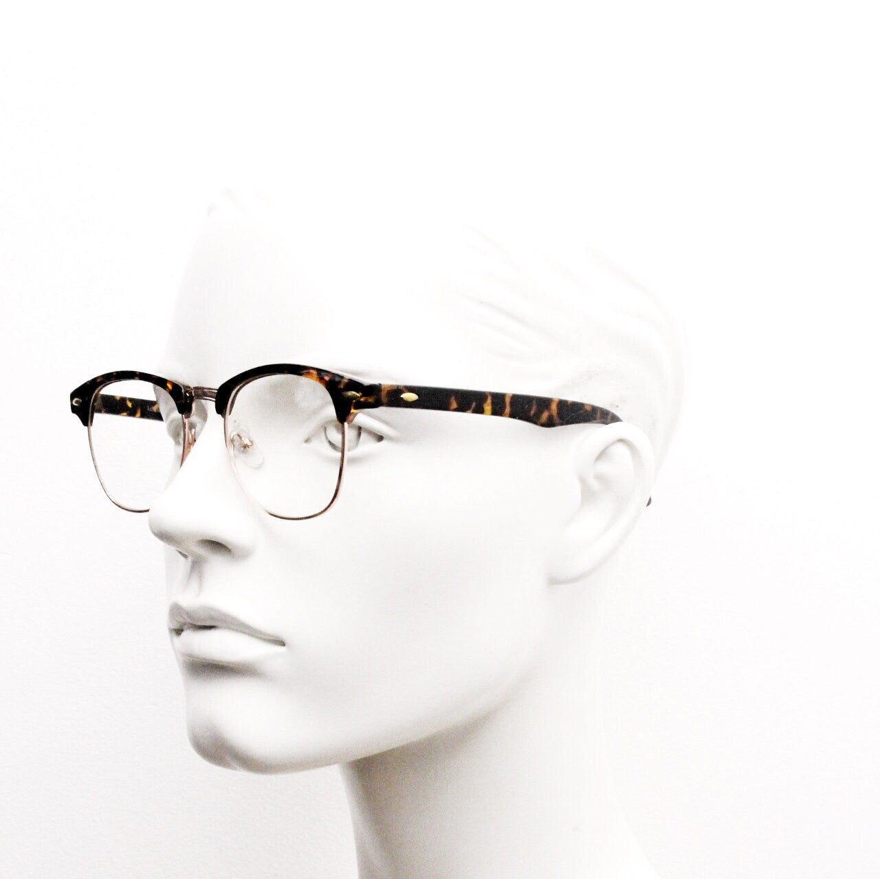 90s vintage half frame glasses. Tortoise browline eyeglasses in a gloss finish with gold underwire and clear lenses . Mens 50s, 60s design