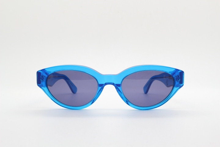 Retrosuperfuture thick cat eye sunglasses hand made in Italy. Intense blue acetate chunky frame with tasteful navy lenses. NOS