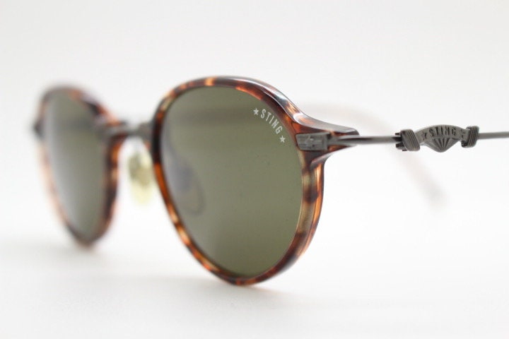 Sting 90s vintage oval sunglasses made in Italy. Refined 'industrial tech' fused with 1930s style in bronze metal and tortoise . Unused NOS