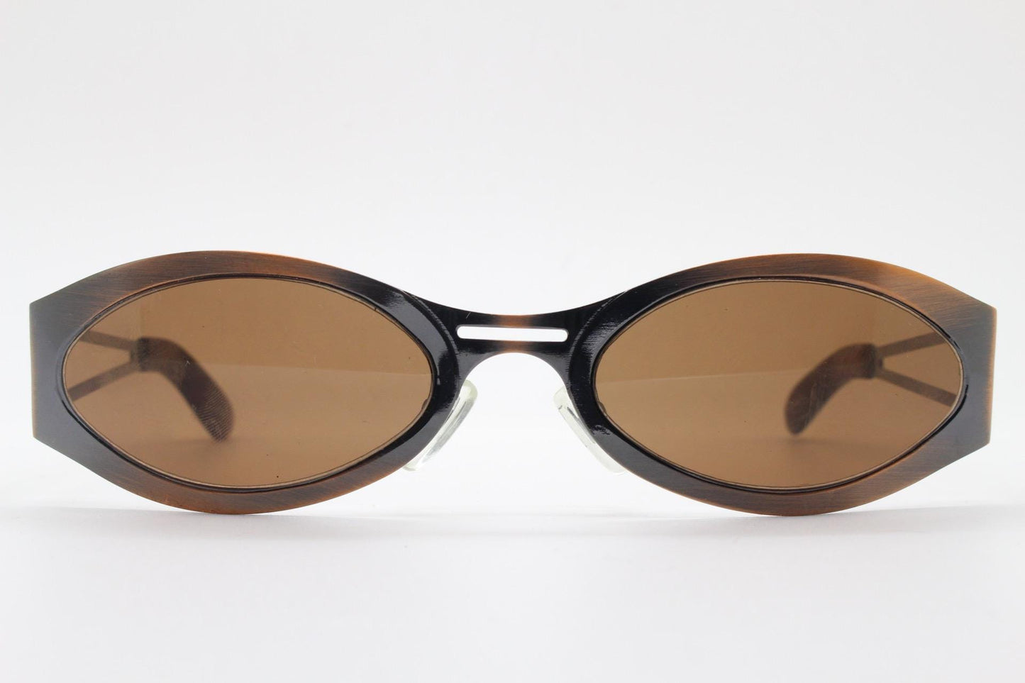 2000s vintage wraparound angular sunglasses. brushed copper finish flat curved metal frame with cut out arms. 90s. Y2K unused NOS