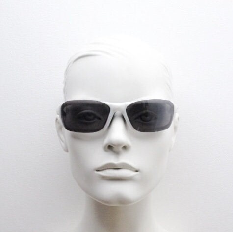 Y2K vintage visor sunglasses. Black and white superhero style sport shield with curved black lenses. Aerodynamic wrap around. NOS rave