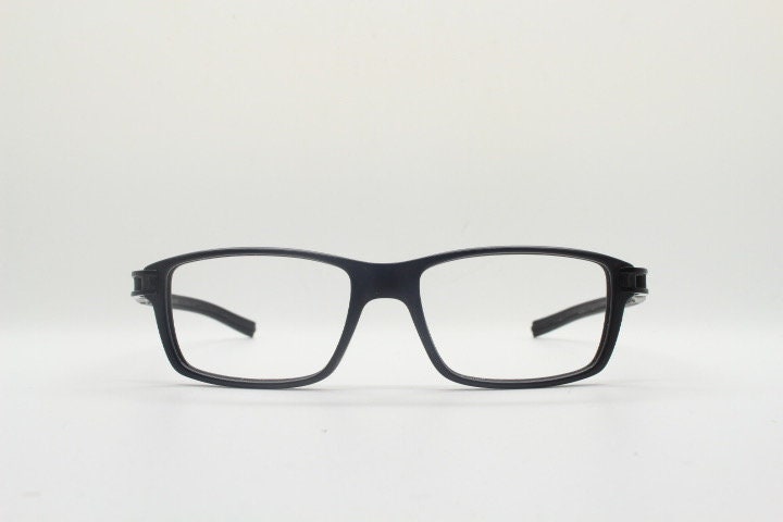 Tag Heuer rectangular eye glasses. Patented design made in France. Solid acetate optical frame with flexible rubber arms. Prescription RX