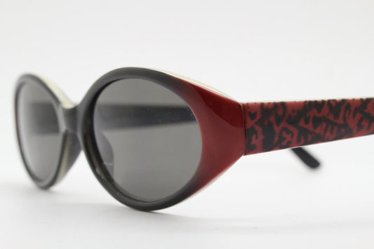 Vintage 90s oval sunglasses with very unique abstract arm pattern in black and red on layered acetate. Authentic original design. NOS