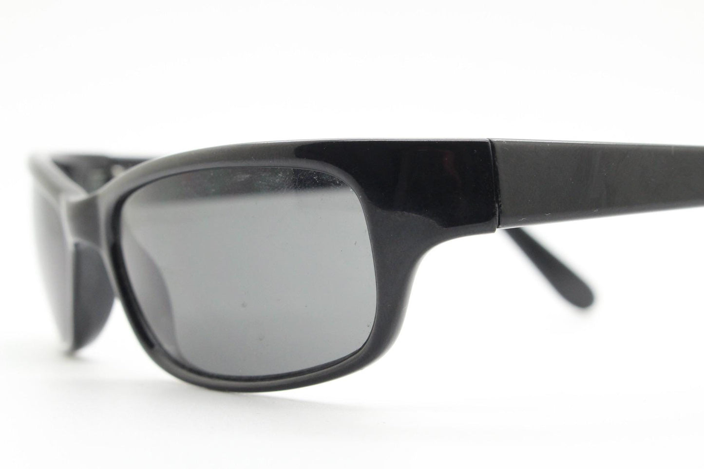 90s vintage curved wraparound sunglasses. Aerodynamic low profile plain black gloss curved cat eye frame. Minimal shield design. NOS