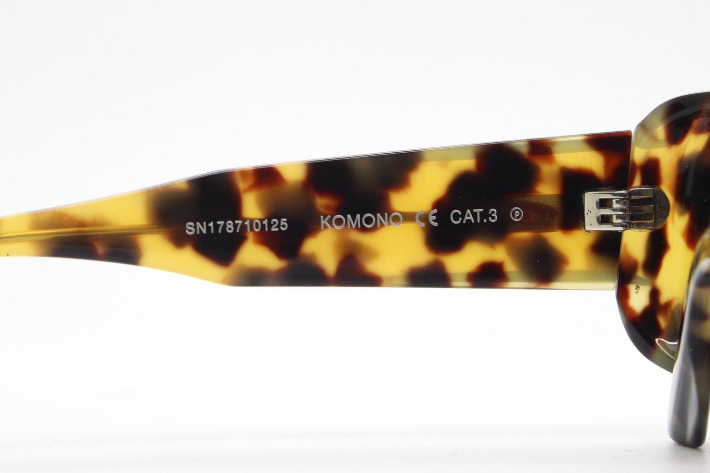 Komono chunky rectangular sunglasses model The Wes. Thick framed honey tortoise eco acetate with curved back 'goggle' sides and tall arms.
