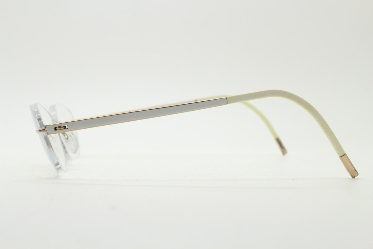 Silhouette rectangular frameless eye glasses made in Austria. Minimal lightweight gold with white enamel frame. 90s vintage. Prescription RX