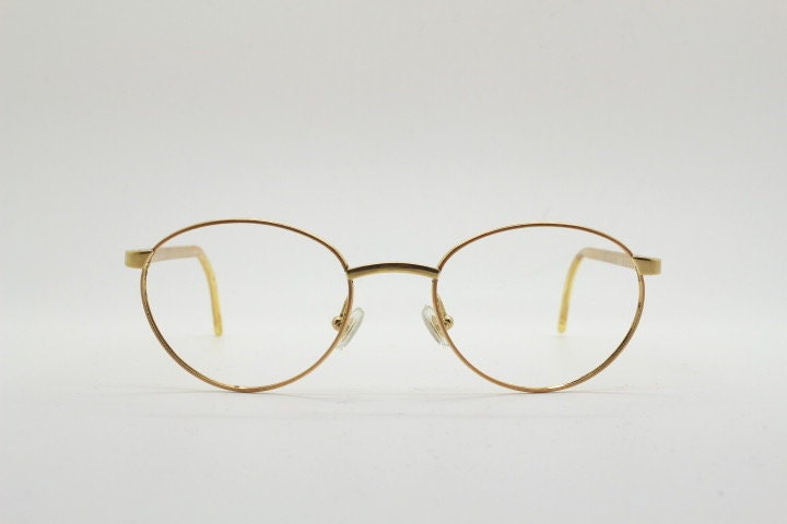 Christian Dior 90s vintage oval eye glasses made in Austria. Lustrous gold finish optical frame with CD chain link arms. Prescription RX NOS