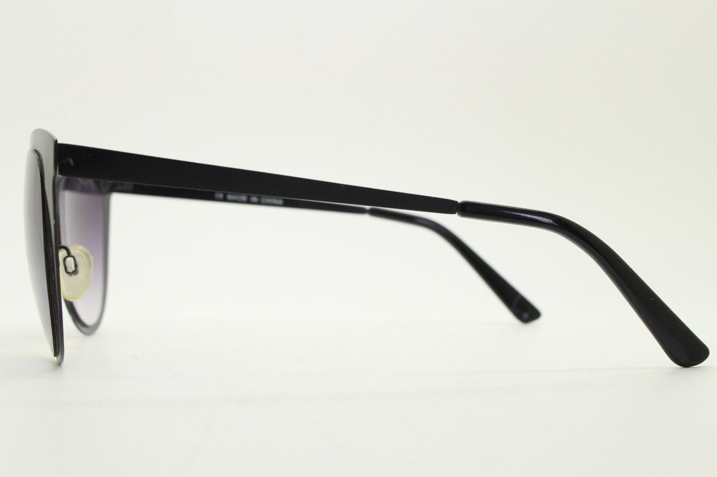 Vintage pointed cat eye sunglasses. Flat metal frame in a satin finish encasing smoky grey graduating lenses. Womens cateye