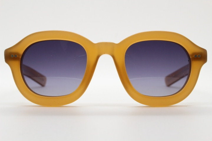 Kopajos thick framed round sunglasses. Hand made transparent amber acetate chunky frame with contrasting graduating lenses