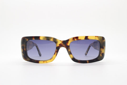 Komono chunky rectangular sunglasses model The Wes. Thick framed honey tortoise eco acetate with curved back 'goggle' sides and tall arms.