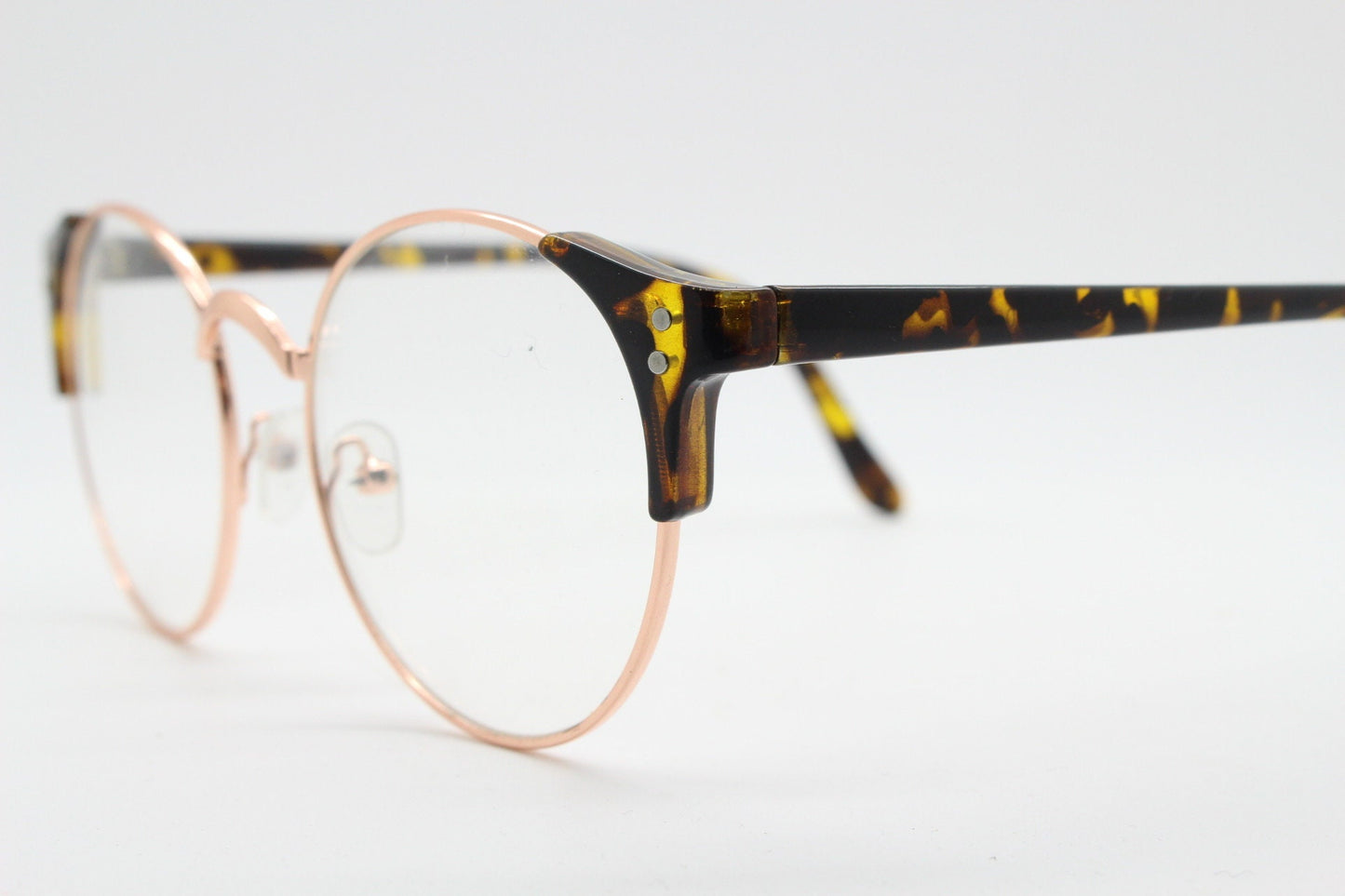 90s vintage modified cat eye glasses. Tortoise arms with a round gold face. 40s, 50s style clear lens eyeglasses. Cateye