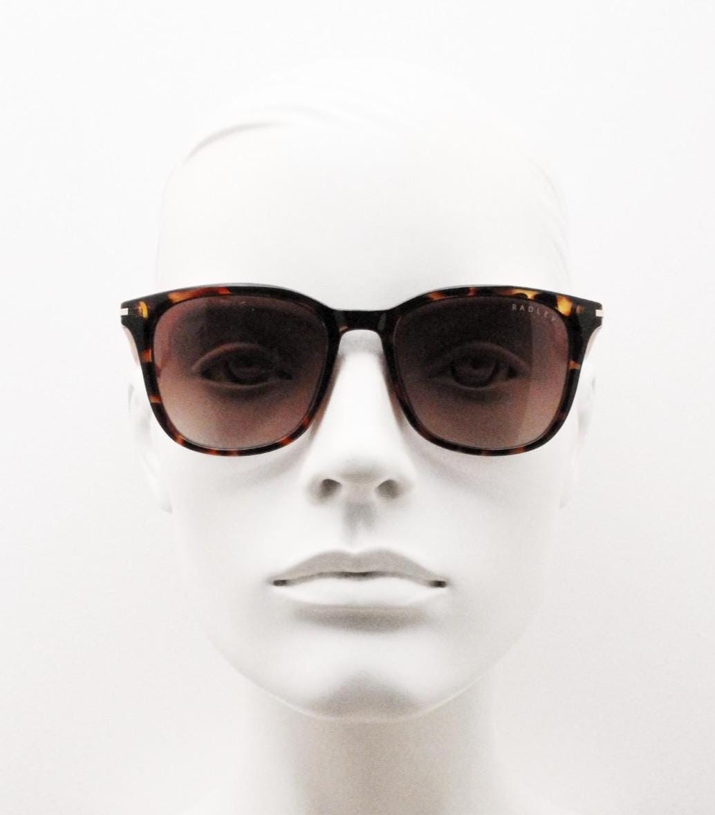 Modified wayfarer design sunglasses by Radley. Tortoise front with bright orange arms and Havana brown lenses. Vintage. Unused NOS