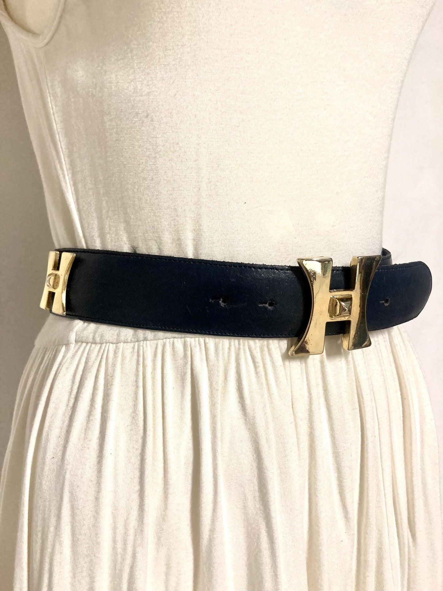80s vintage womens dress belt in navy blue genuine leather with substantial gold chrome studded 'H' motifs. Made in France. Size S
