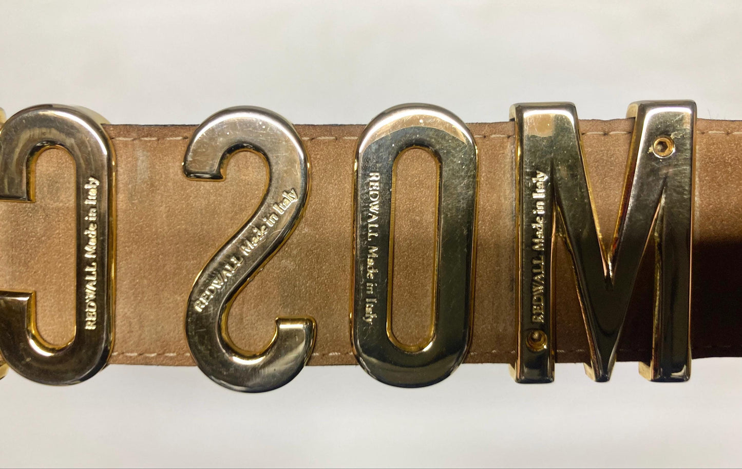 Moschino 90s vintage womens dress belt in black genuine leather. Iconic individual golden moving letters logo. Made in Italy. 80s. NOS