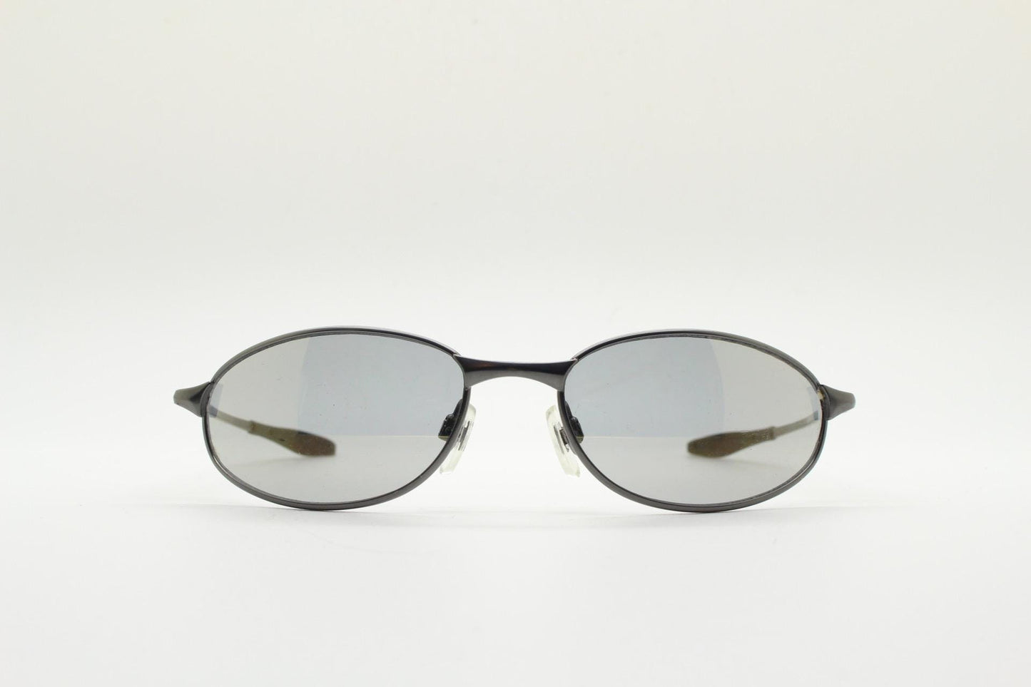 90s vintage oval small  bug eye sunglasses. Satin finish frame in gunmetal with straight spear arms. Y2K. 2000s. Unworn NOS
