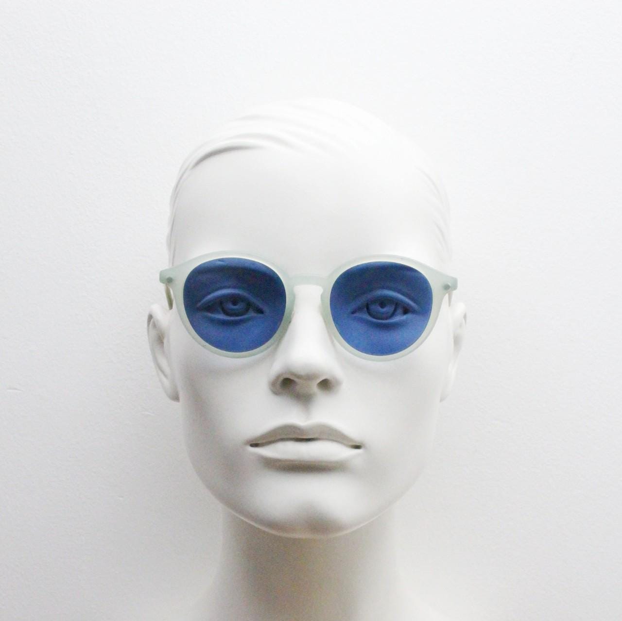 Sergio Tacchini 80s vintage round horn rim sunglasses made in Italy. Transparent pale blue frosted acetate frame with navy lenses. NOS