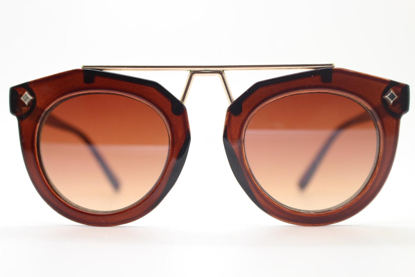 Rounded cateye sunglasses with gold 'scaffold' metal bridge. Women's transparent frame with matching brown graduating lenses. Vintage NOS