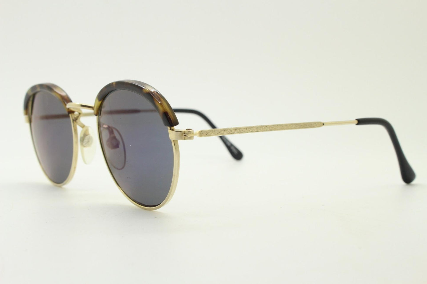 90s round vintage sunglasses. Gold frame with tortoise brows, blue mirror lenses and intricate embossed arm patterns. 1930's style