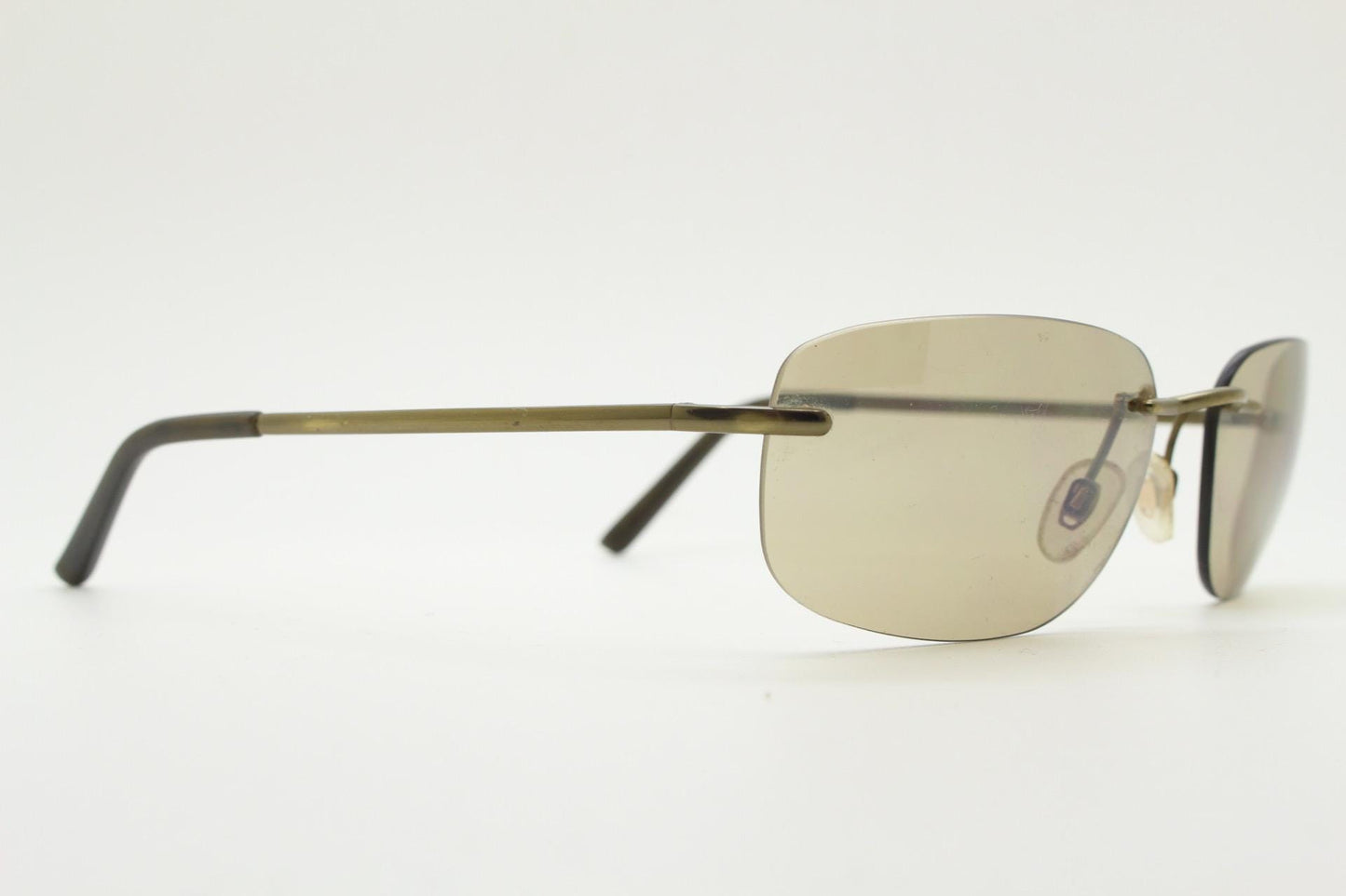 Ben Sherman 90s vintage frameless sunglasses. Minimal brown rectangular lens with brown chrome trim in neat proportions. Mens Mod shades