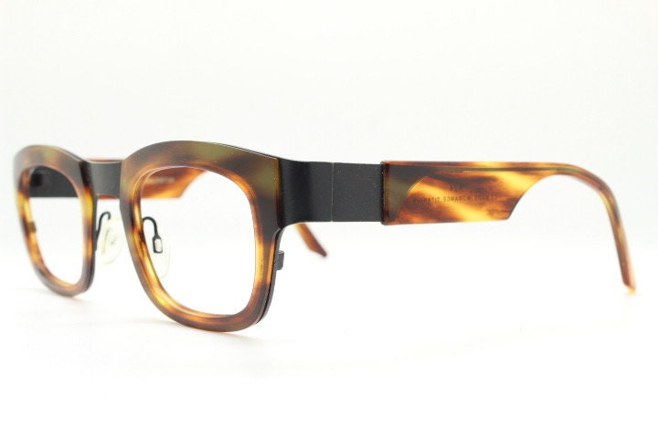 Anne et Valentin rectangular eye glasses hand made in France. Black matt titanium optical frame with mottled brown acetate. Prescription RX