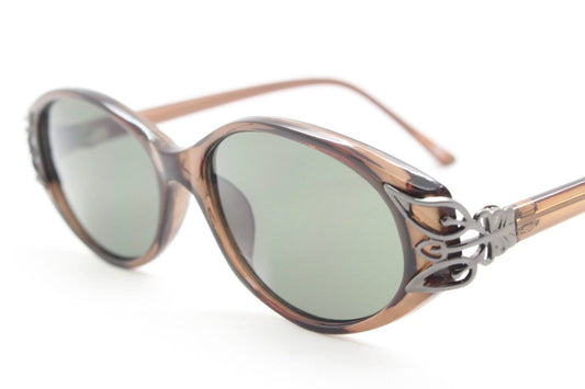 90s vintage oval cateye sunglasses. Womens transparent brown low profile cat eye frame with decorative metal corners. Unused NOS cateyes