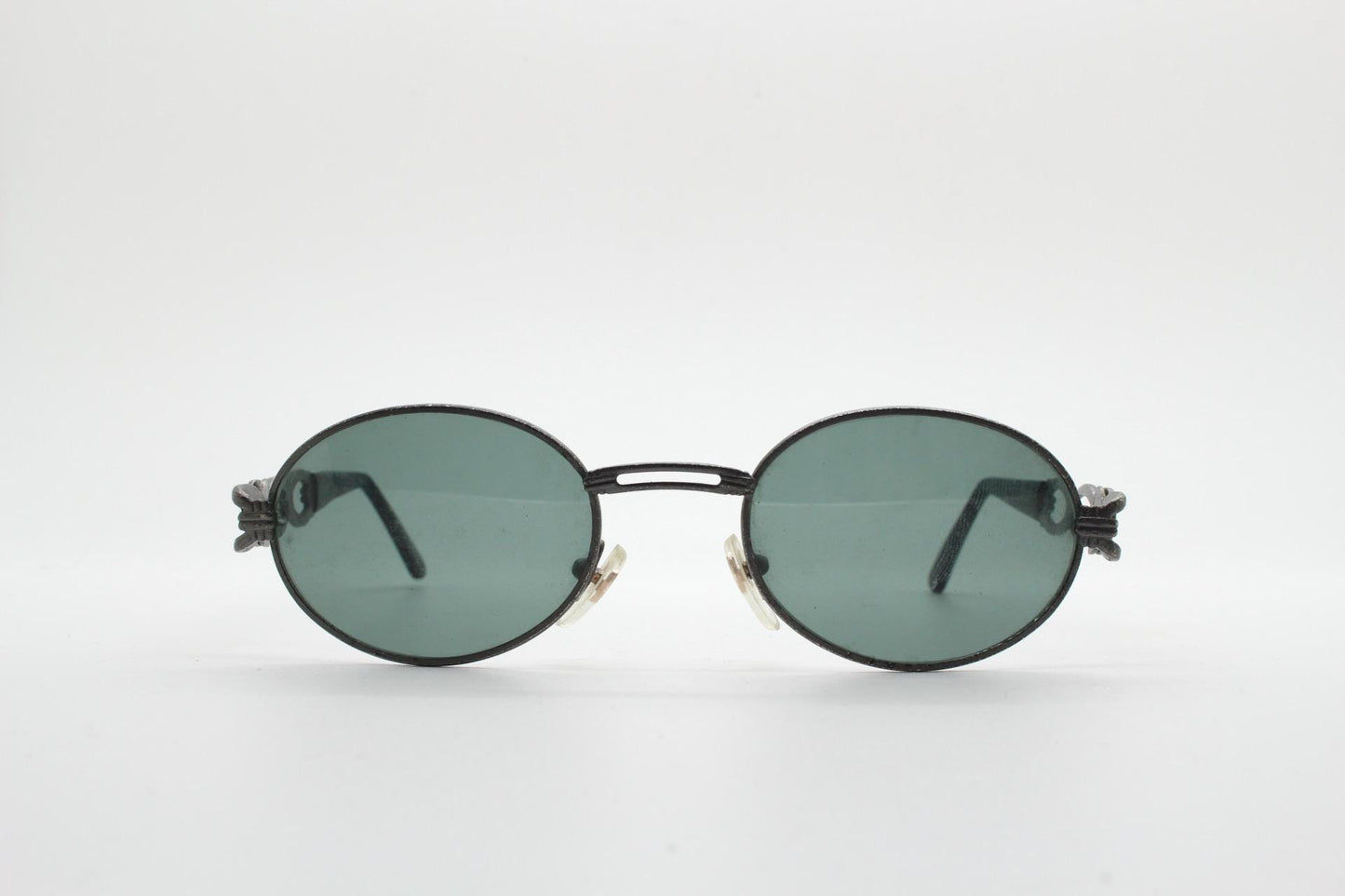 90s vintage low profile oval sunglasses. Authentic Gunmetal grey satin finish frame with chain link arm circles and real glass lenses. NOS