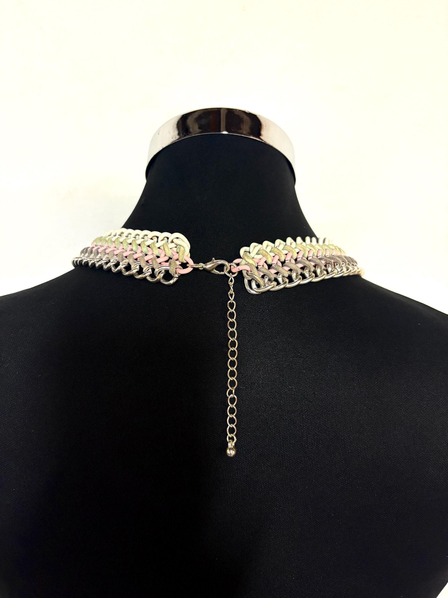 90s vintage 3 tier chain necklace. Solid metal construction in silver, pink, and white tones with grey rubber bonds. Adjustable back