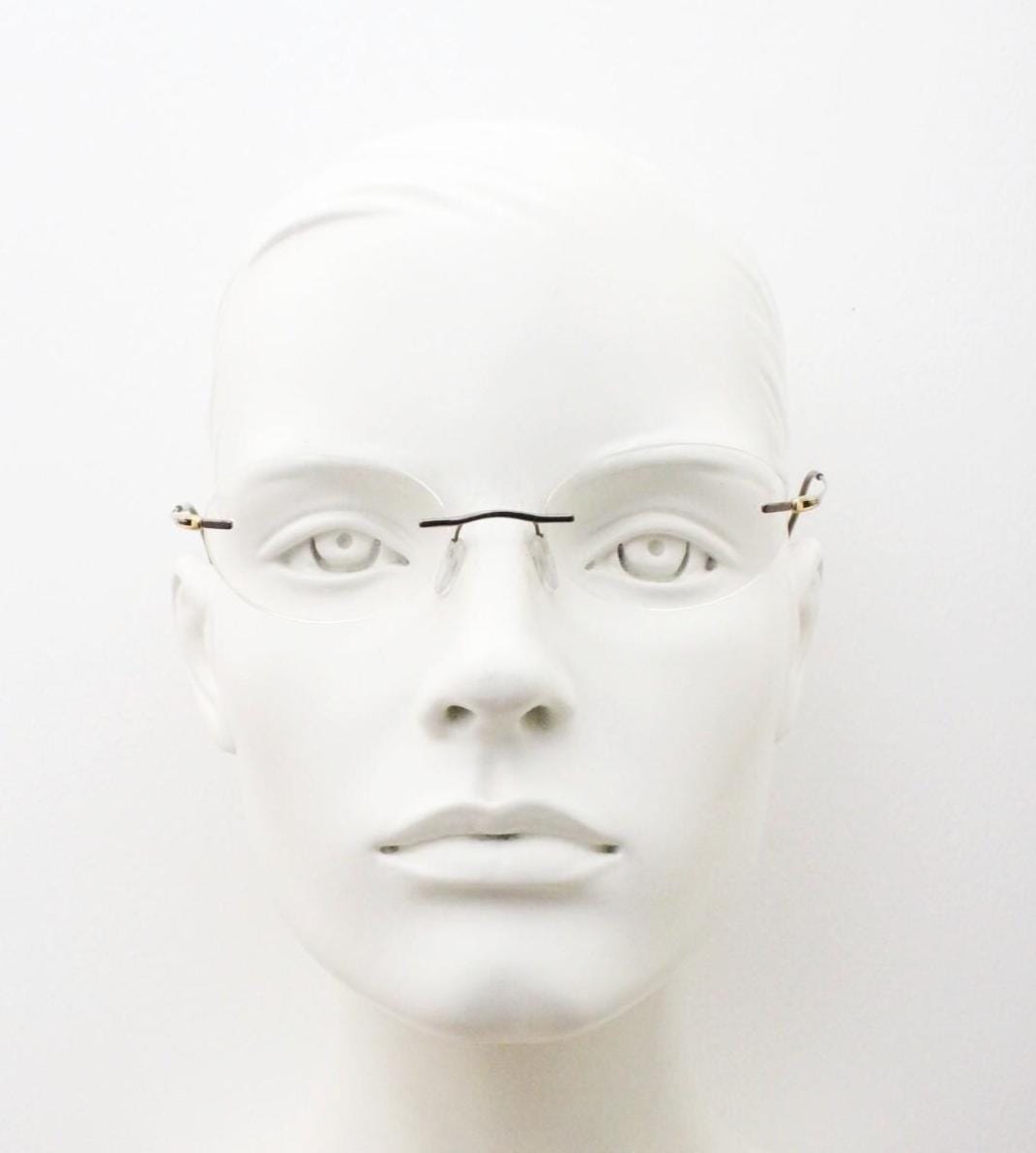 Silhouette vintage oval frameless eye glasses made in Austria. Minimal lightweight satin bronze optical frame. Prescription spectacles