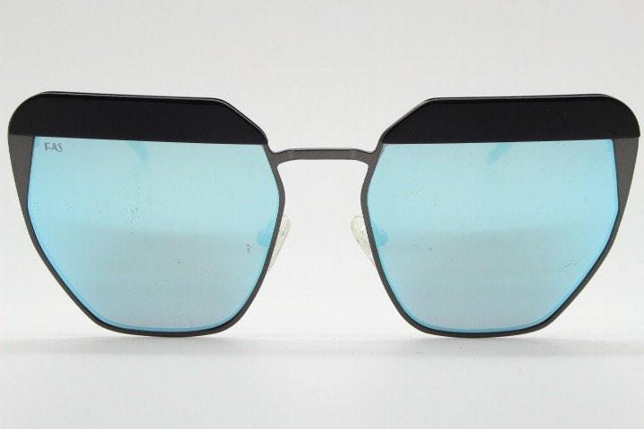 For Arts Sake angular cat eye hand made sunglasses. Black flat top 'eyebrow' design with blue mirror lenses and gunmetal grey frame