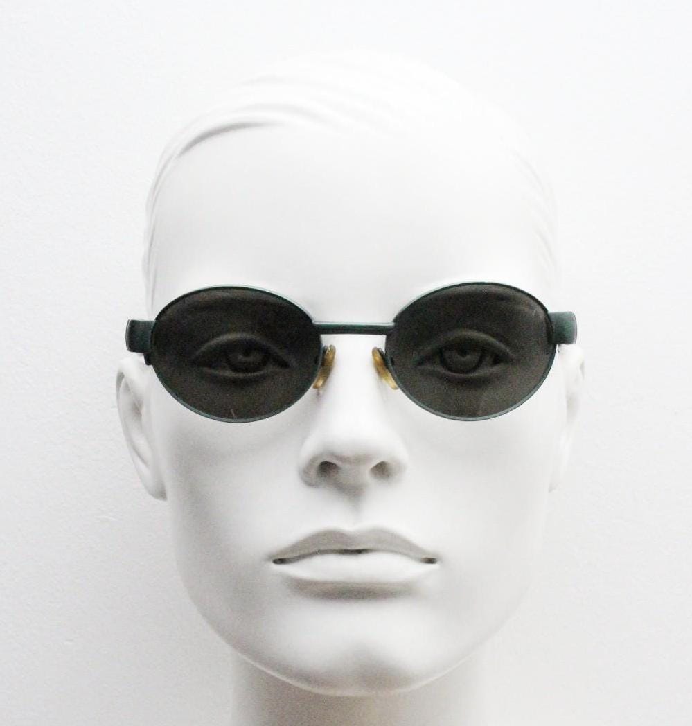 Safilo for Oxydo 90s vintage oval sunglasses made in Italy. Green matt finish solid metal frame with black arms and green lenses. Unused NOS
