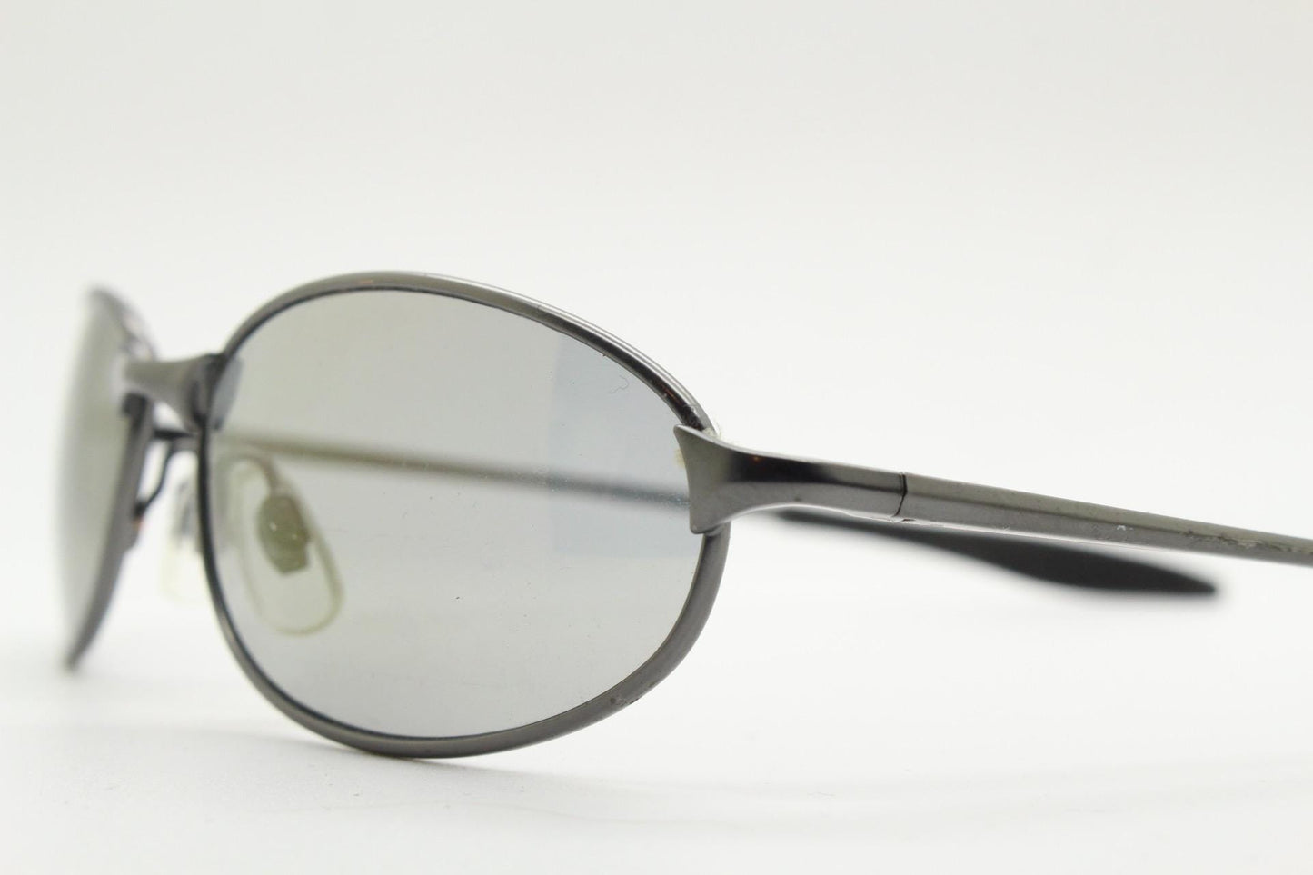 90s vintage oval small  bug eye sunglasses. Satin finish frame in gunmetal with straight spear arms. Y2K. 2000s. Unworn NOS