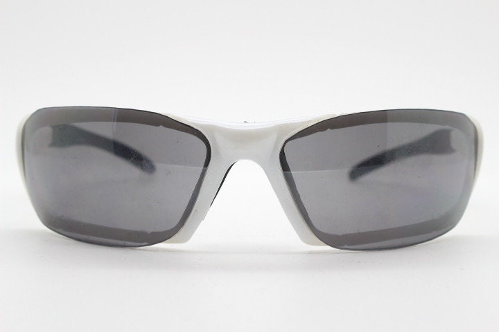Y2K vintage visor sunglasses. Black and white superhero style sport shield with curved black lenses. Aerodynamic wrap around. NOS rave