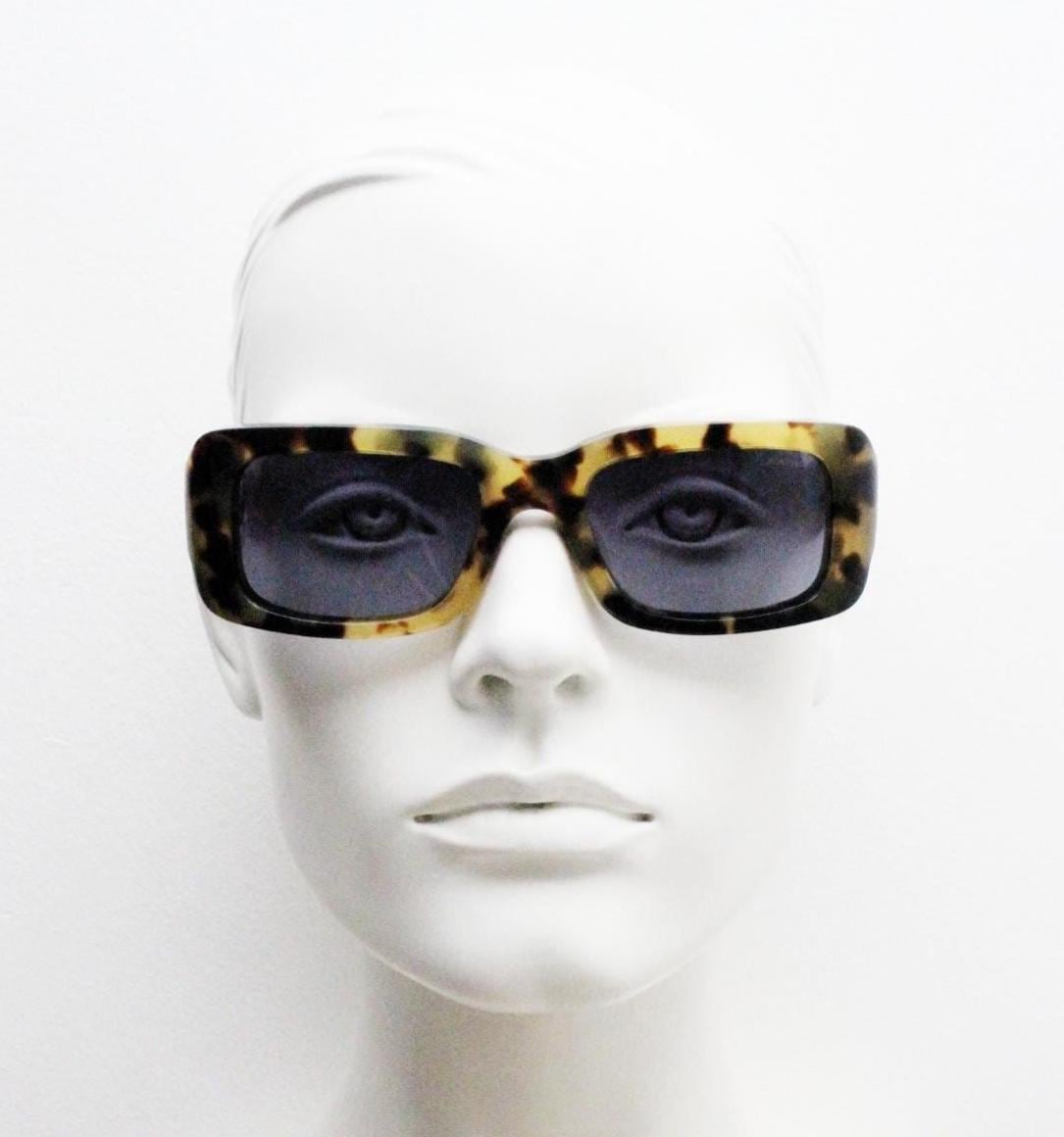 Komono chunky rectangular sunglasses model The Wes. Thick framed honey tortoise eco acetate with curved back 'goggle' sides and tall arms.