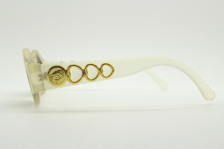 Vintage 90s oval transparent sunglasses. Frosted frame with dark green lenses and heart shaped chain link arms. Unworn NOS