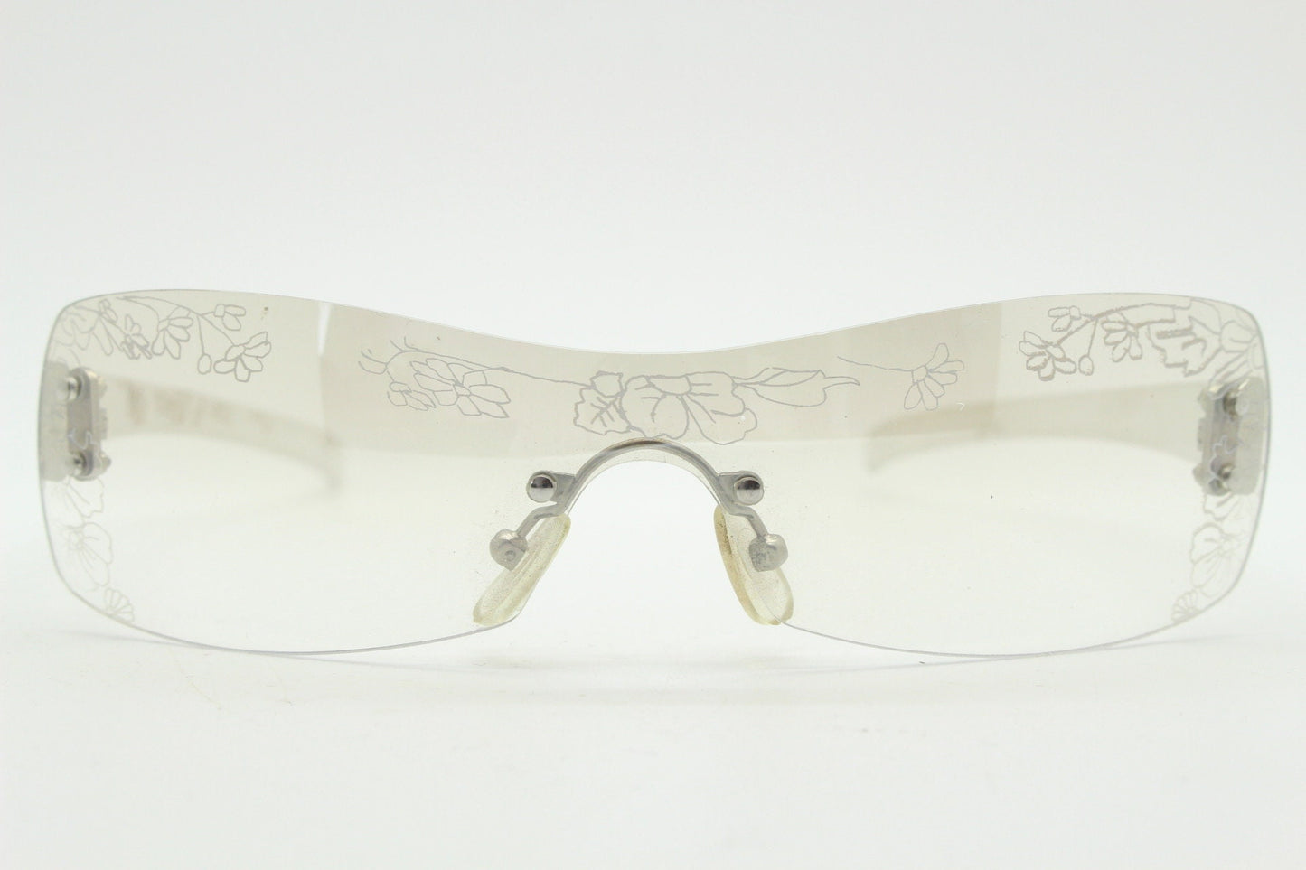 Y2K vintage visor sunglasses. Frameless 2000's wraparound mini mask shield design with light tone mirror mono lens and flower print. 00s NOS