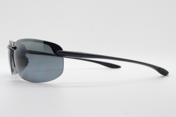 Maui Jim sport wrap around sunglasses made in Japan. Lightweight half frame shield with curving lenses. 2000's. Y2K