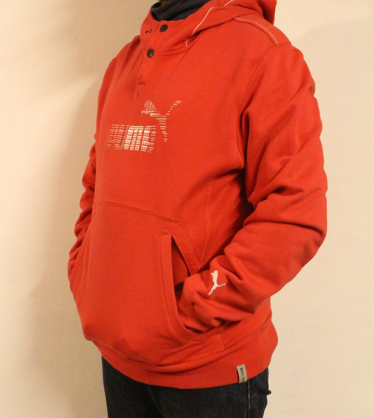 Puma red hoody with big chest logo. Unisex sports pullover sweatshirt with front muffler pockets. UK size L