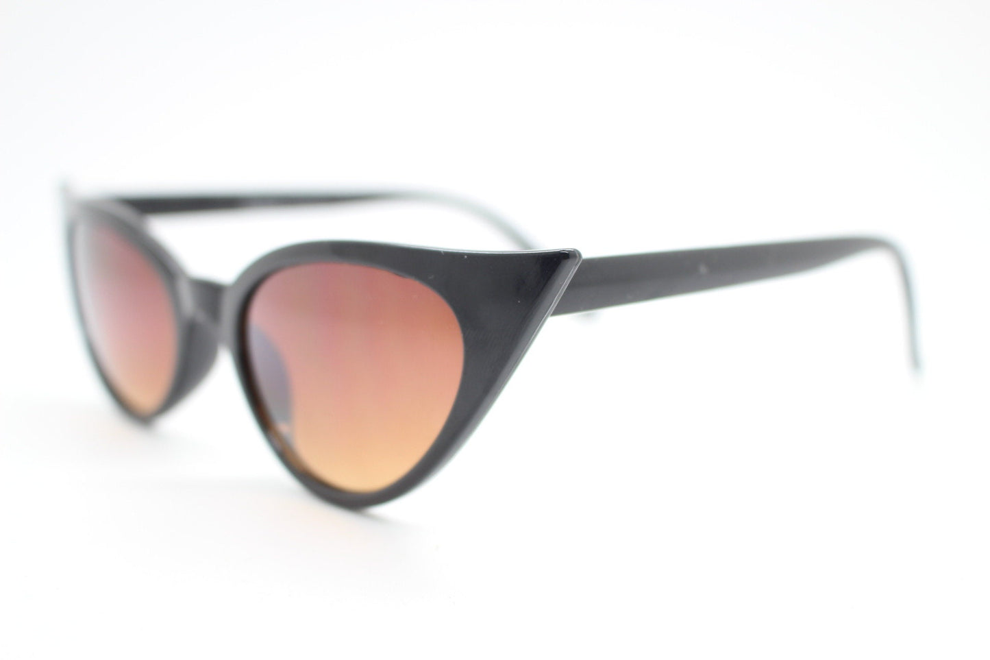 Y2K vintage pointed cat eye sunglasses. Womens black slender 50s style frame with Havana brown lenses. Rockabilly, bad girl pin up