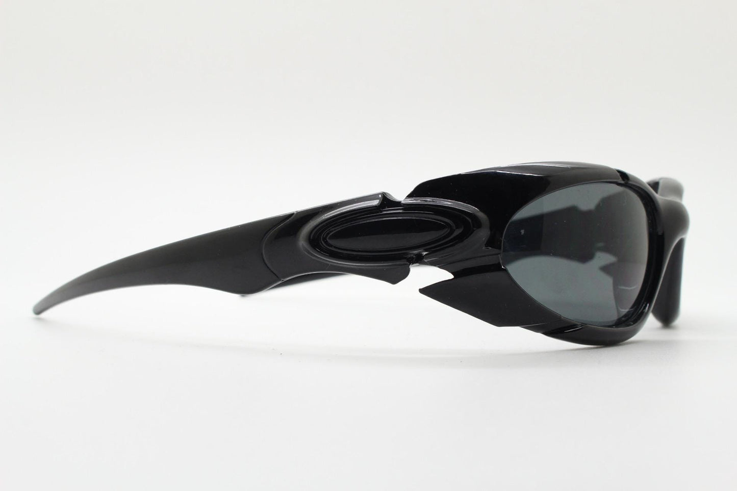 90s vintage sports shield sunglasses. All black gloss aerodynamic wraparound with many stylised features. 2000's. Hells angel uber fashion