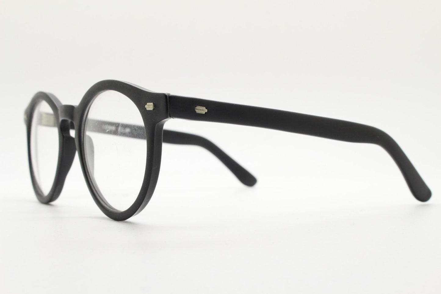 Oliver Smith round eye glasses. Black matt finish optical frames with protruding corners and keyhole bridge. Prescription RX eyeglasses