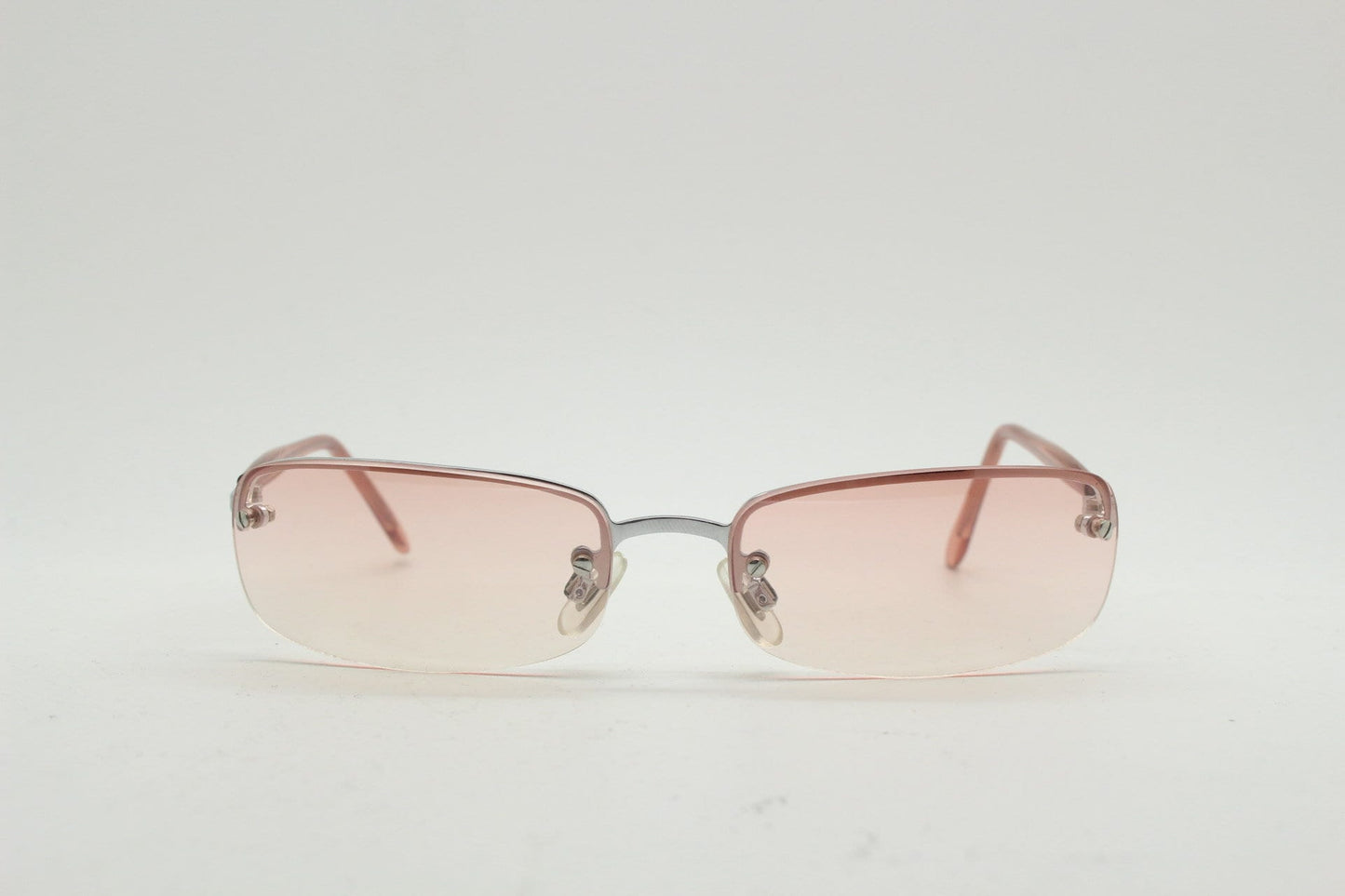 Y2K vintage wrap around rectangular sunglasses. Half frame in sharp chrome with extra light tone pink lenses. Rave 2000's. 00's NOS